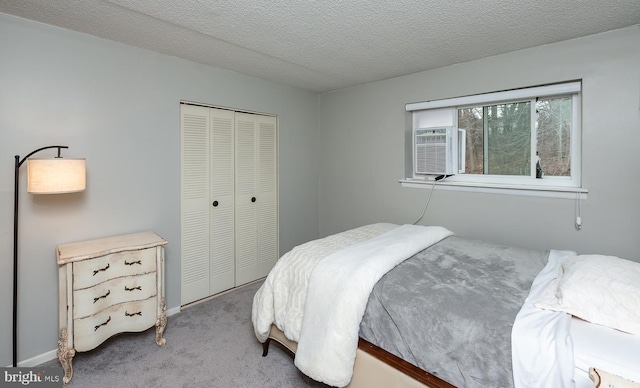 carpeted bedroom featuring a closet and a textured ceiling