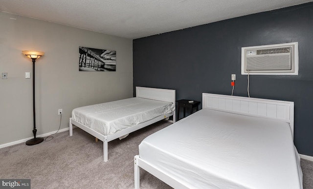 carpeted bedroom with baseboards and a wall mounted AC