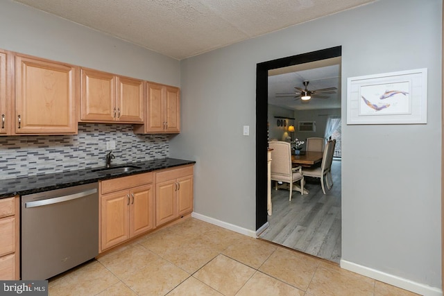 kitchen featuring light brown cabinets, a sink, backsplash, light tile patterned floors, and dishwasher