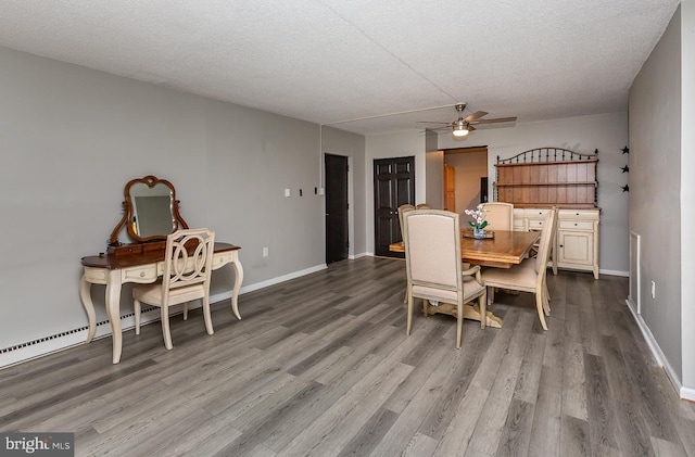 dining space featuring baseboards, wood finished floors, a textured ceiling, and ceiling fan