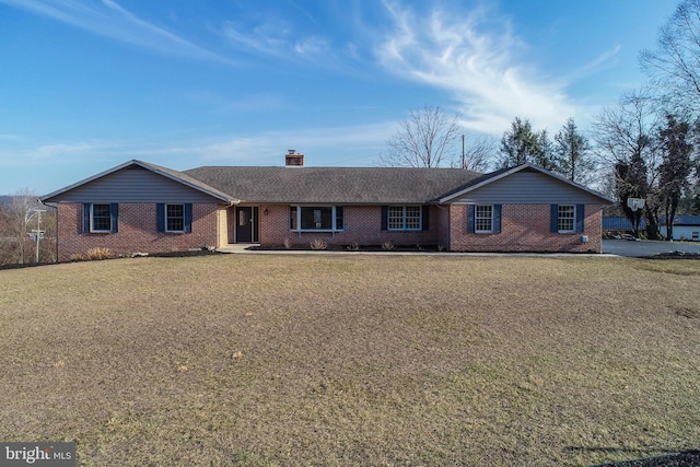 single story home with brick siding, a chimney, a front lawn, and roof with shingles