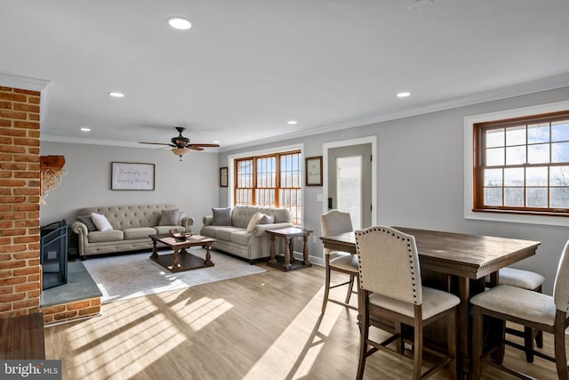 dining space featuring a wealth of natural light, recessed lighting, light wood finished floors, and ornamental molding