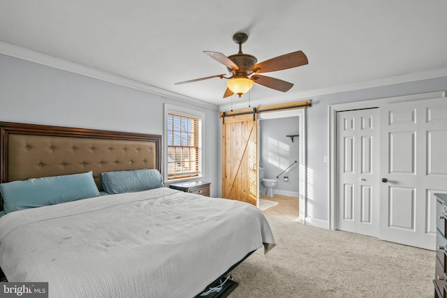 carpeted bedroom featuring a barn door, crown molding, baseboards, and connected bathroom