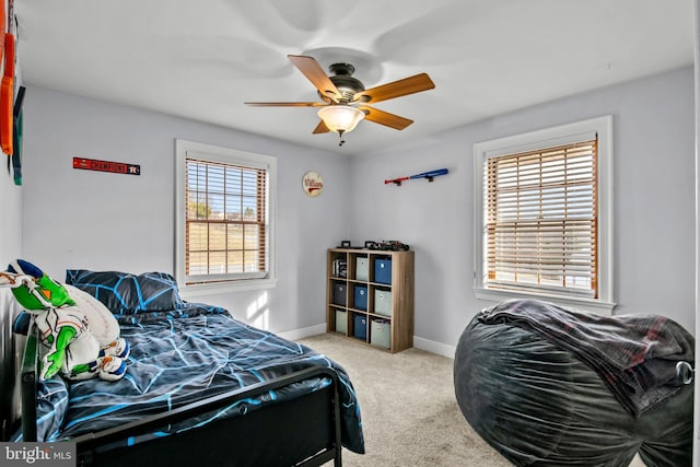 bedroom with baseboards, carpet floors, and a ceiling fan