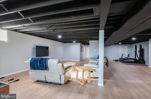 finished basement featuring baseboards and wood finished floors