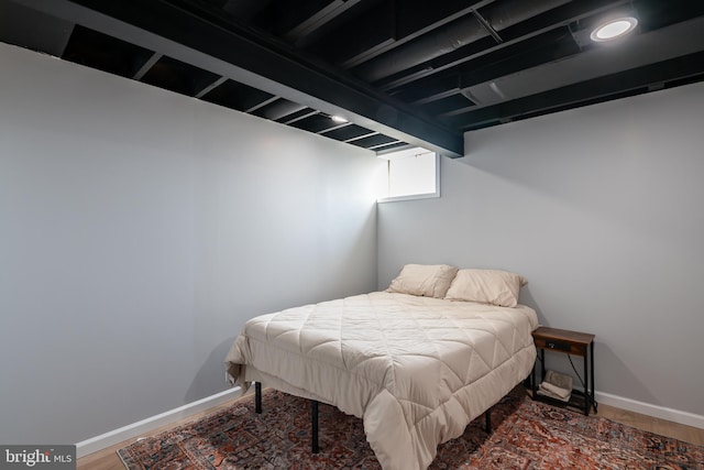 bedroom featuring baseboards and wood finished floors