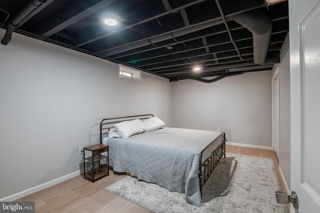 bedroom featuring baseboards and wood finished floors