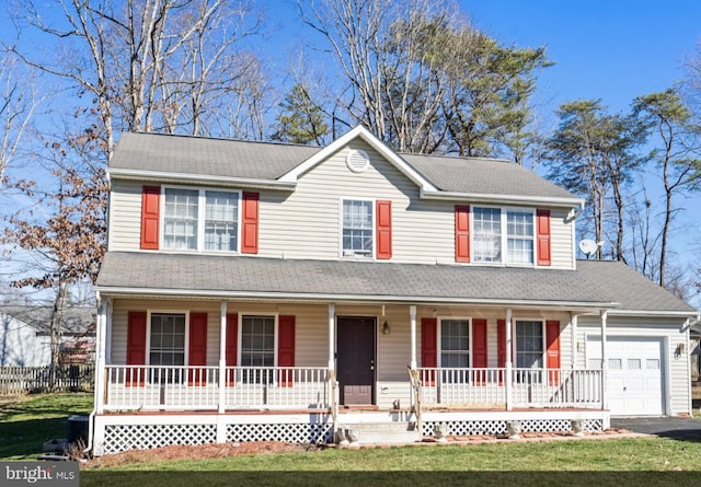 view of front facade with a front yard, roof with shingles, a porch, an attached garage, and aphalt driveway