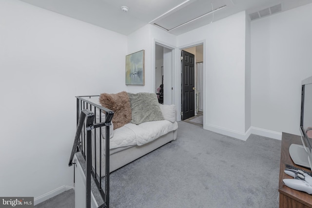 carpeted living room with attic access, baseboards, and visible vents