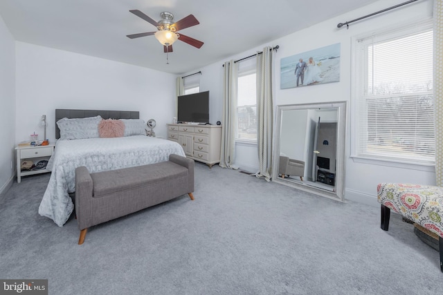 bedroom with baseboards, light carpet, and a ceiling fan