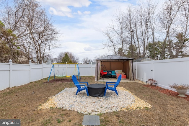 view of yard featuring a patio, a fenced backyard, a carport, outdoor lounge area, and a playground