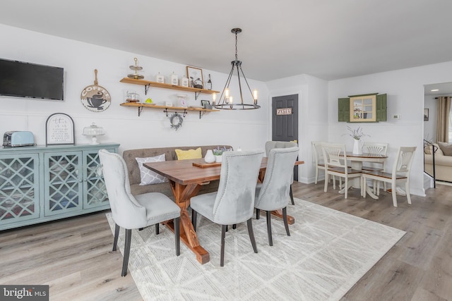 dining space with an inviting chandelier and wood finished floors