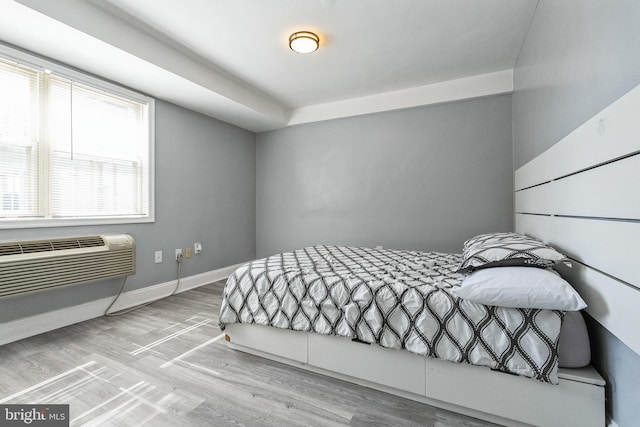 bedroom with baseboards and wood finished floors