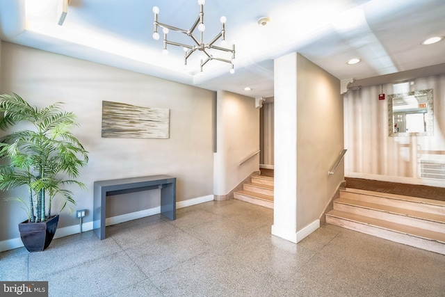 staircase with recessed lighting, baseboards, and an inviting chandelier