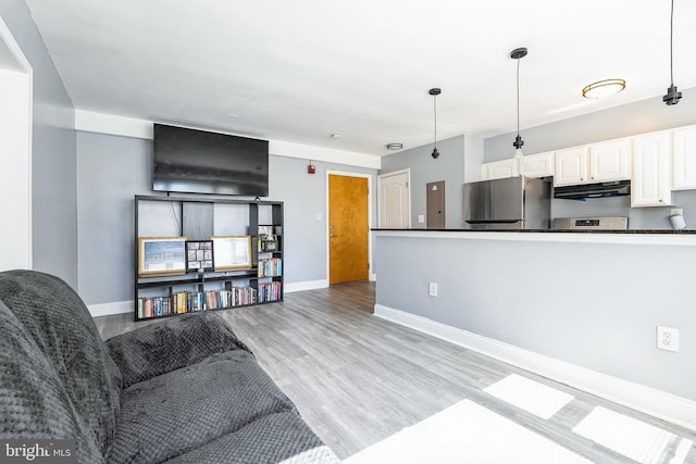 living room with baseboards and light wood-type flooring