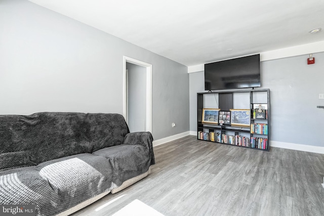 living area with wood finished floors and baseboards