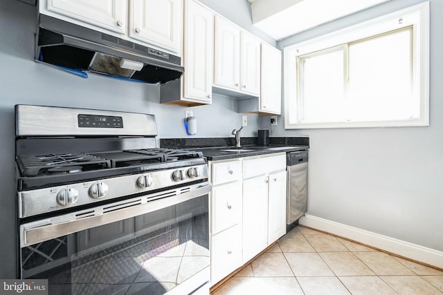 kitchen featuring a sink, white cabinetry, under cabinet range hood, and stainless steel appliances