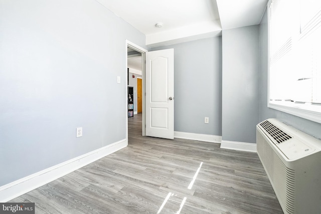 spare room featuring wood finished floors and baseboards