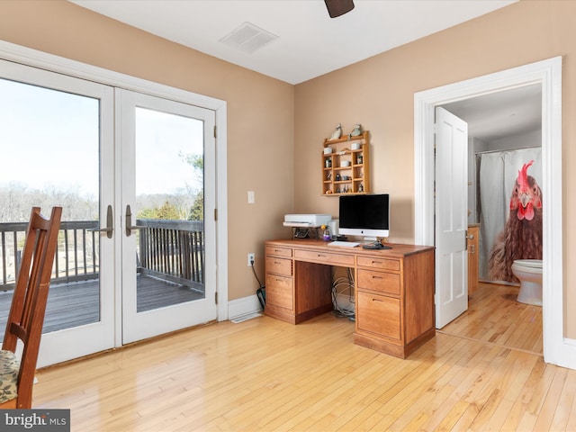 home office featuring a ceiling fan, french doors, visible vents, and light wood finished floors