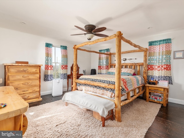 bedroom with ceiling fan, baseboards, and wood finished floors