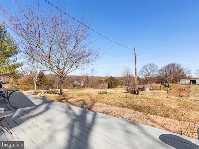 wooden terrace featuring a rural view