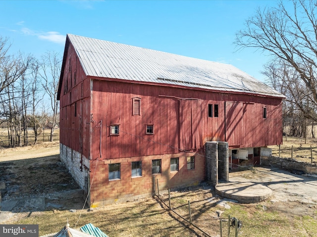 view of side of home featuring an outbuilding and a barn