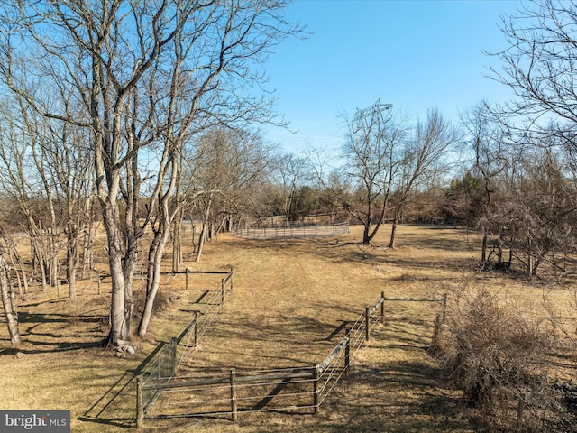 view of yard featuring a rural view and fence