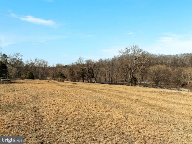 view of local wilderness featuring a rural view and a view of trees