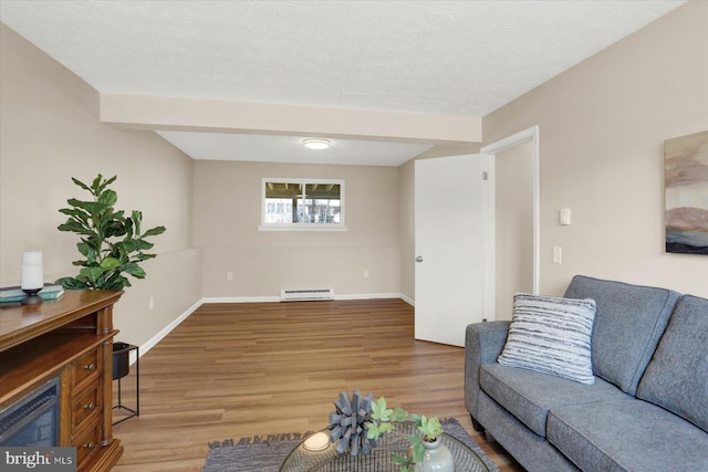 living room featuring a textured ceiling, light wood-type flooring, baseboards, and a baseboard radiator