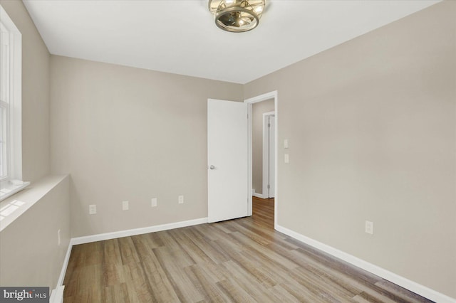 empty room featuring baseboards and wood finished floors