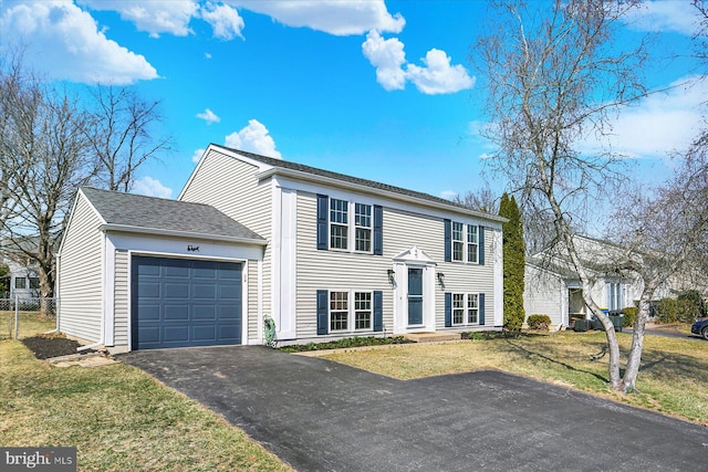 view of front facade with aphalt driveway, a garage, a front lawn, and fence