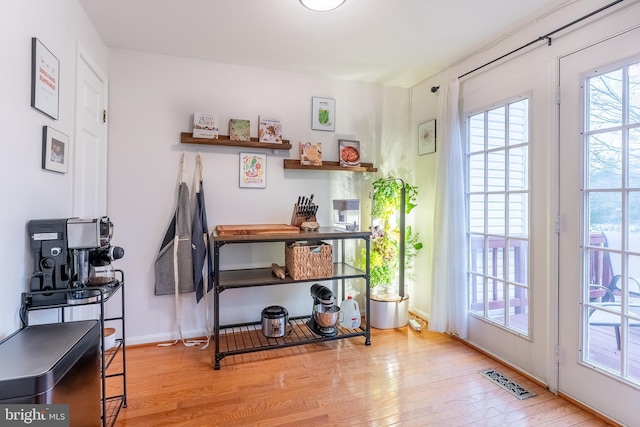 interior space featuring visible vents, baseboards, and wood finished floors