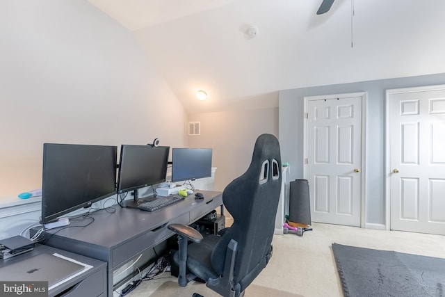 carpeted office space with lofted ceiling, baseboards, and visible vents