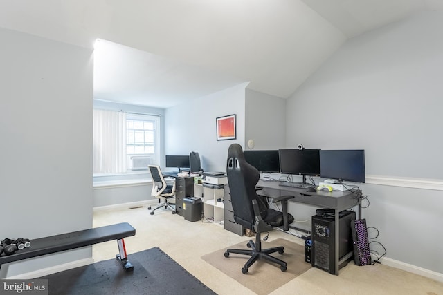 carpeted office space with baseboards and lofted ceiling