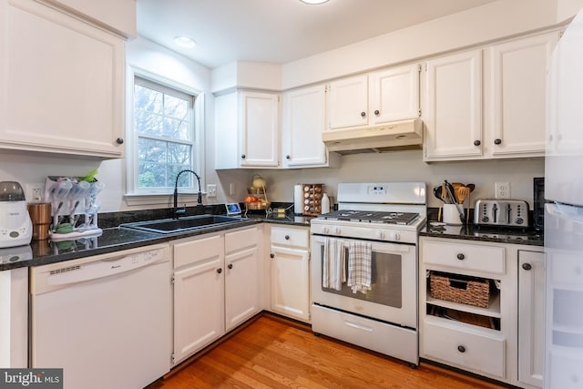 kitchen with light wood-type flooring, under cabinet range hood, a sink, white cabinetry, and white appliances