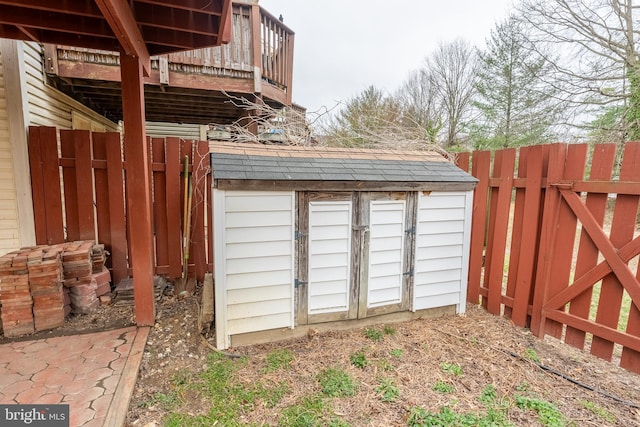 view of shed featuring fence