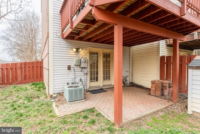 view of patio / terrace featuring central air condition unit and fence