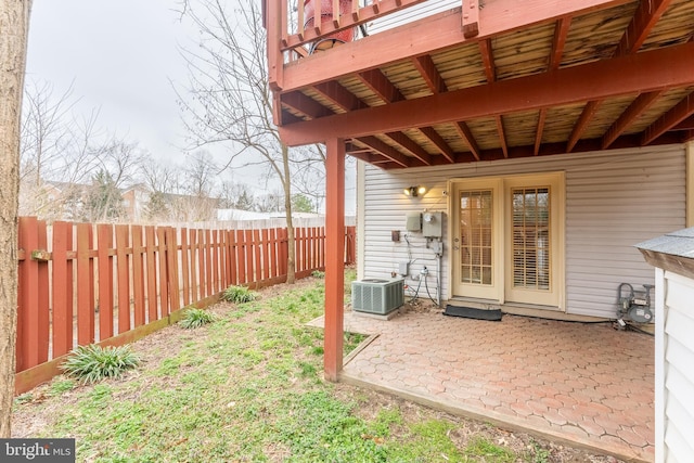 view of yard featuring central AC unit, a patio, and fence