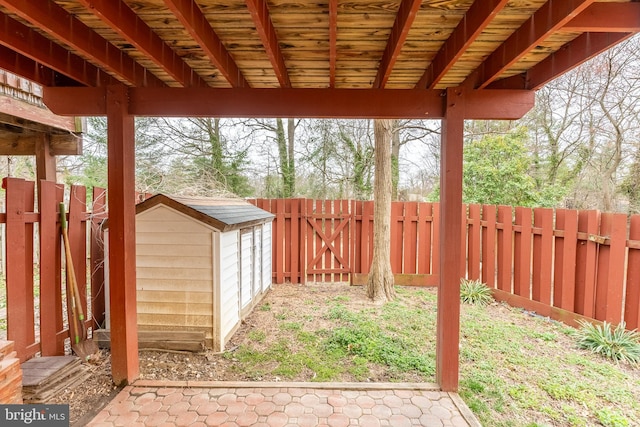 view of yard featuring a storage shed, an outbuilding, and a fenced backyard