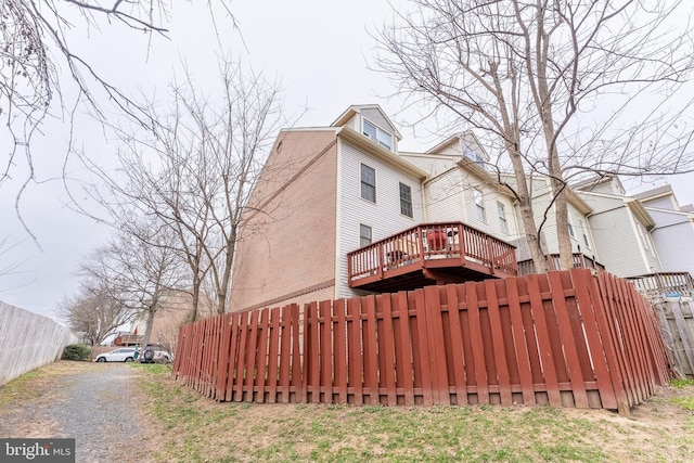 exterior space with gravel driveway and fence