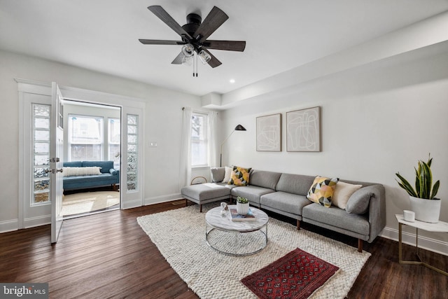 living room featuring recessed lighting, baseboards, and dark wood-style flooring