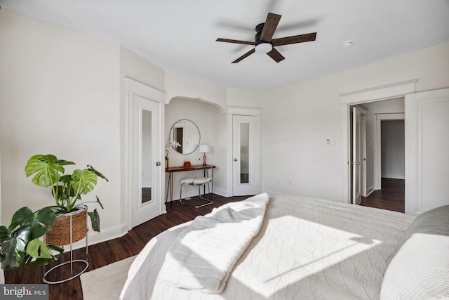 bedroom with ceiling fan, baseboards, and wood finished floors