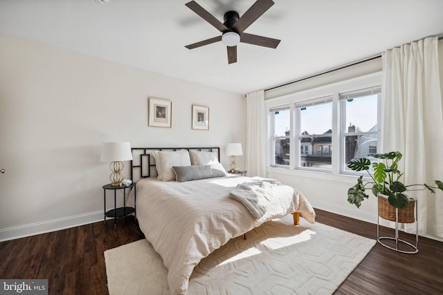 bedroom with baseboards, wood finished floors, and a ceiling fan