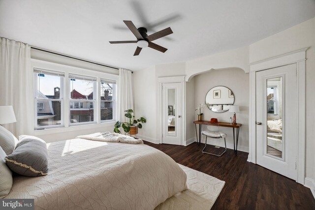 bedroom with dark wood finished floors, baseboards, and ceiling fan