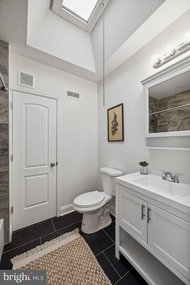 bathroom with tile patterned flooring, toilet, vanity, and visible vents