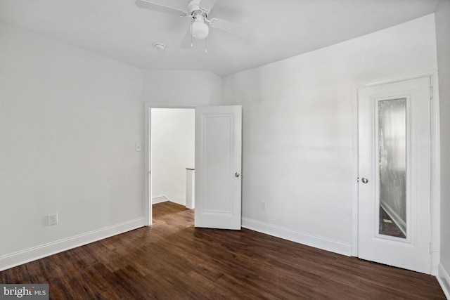 unfurnished room featuring dark wood-style floors, baseboards, and ceiling fan