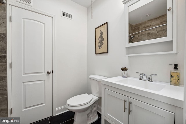 bathroom featuring visible vents, toilet, and vanity