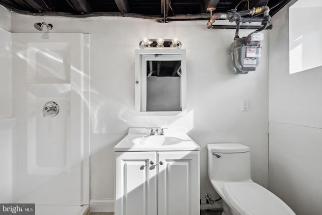 bathroom featuring a shower, toilet, and vanity