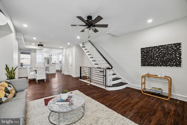 living area with wood finished floors, baseboards, recessed lighting, ceiling fan, and stairs