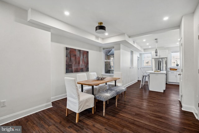 dining area with dark wood finished floors, recessed lighting, and baseboards